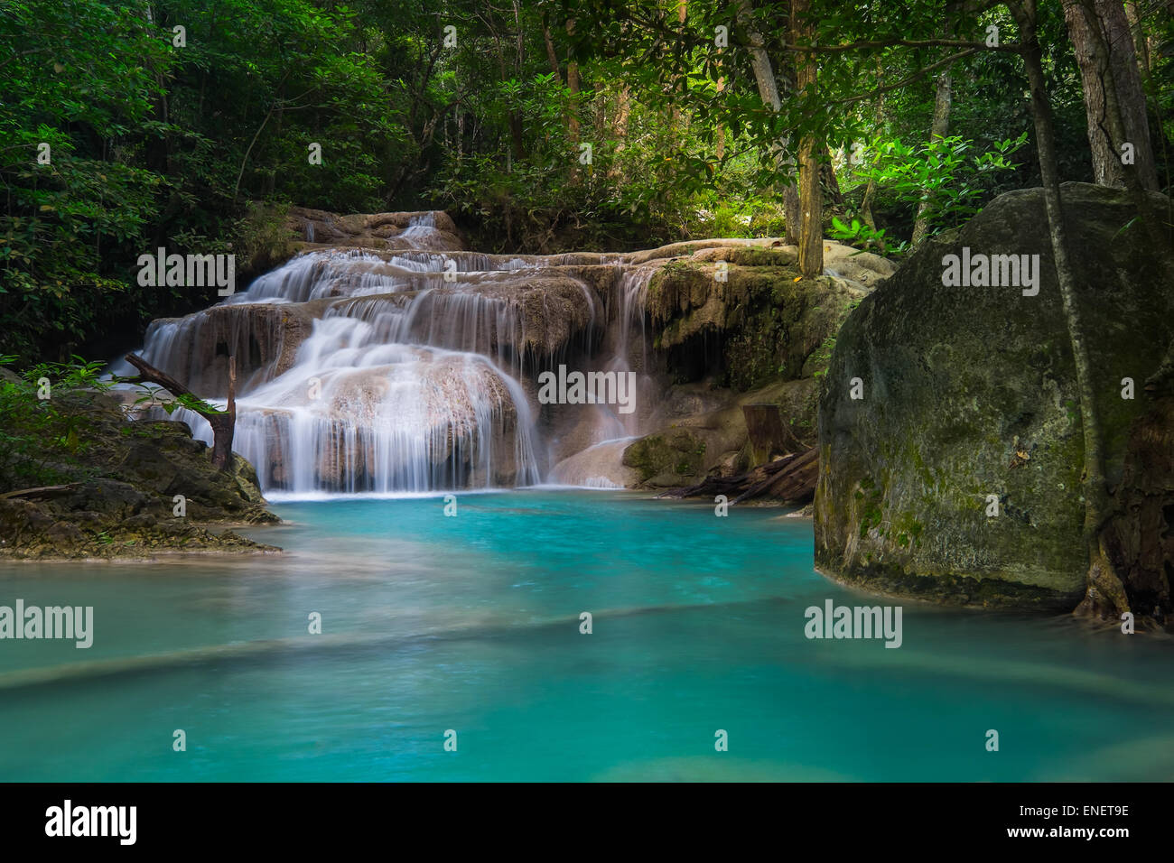 Jangle landscape with flowing turquoise water of Erawan cascade waterfall at deep tropical rain forest. National Park Kanchanabu Stock Photo