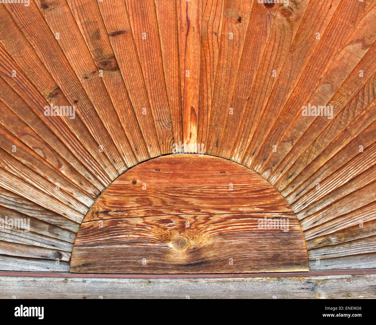 Close up of weathered wood craftsmanship design as a sun with sunbeams. Stock Photo