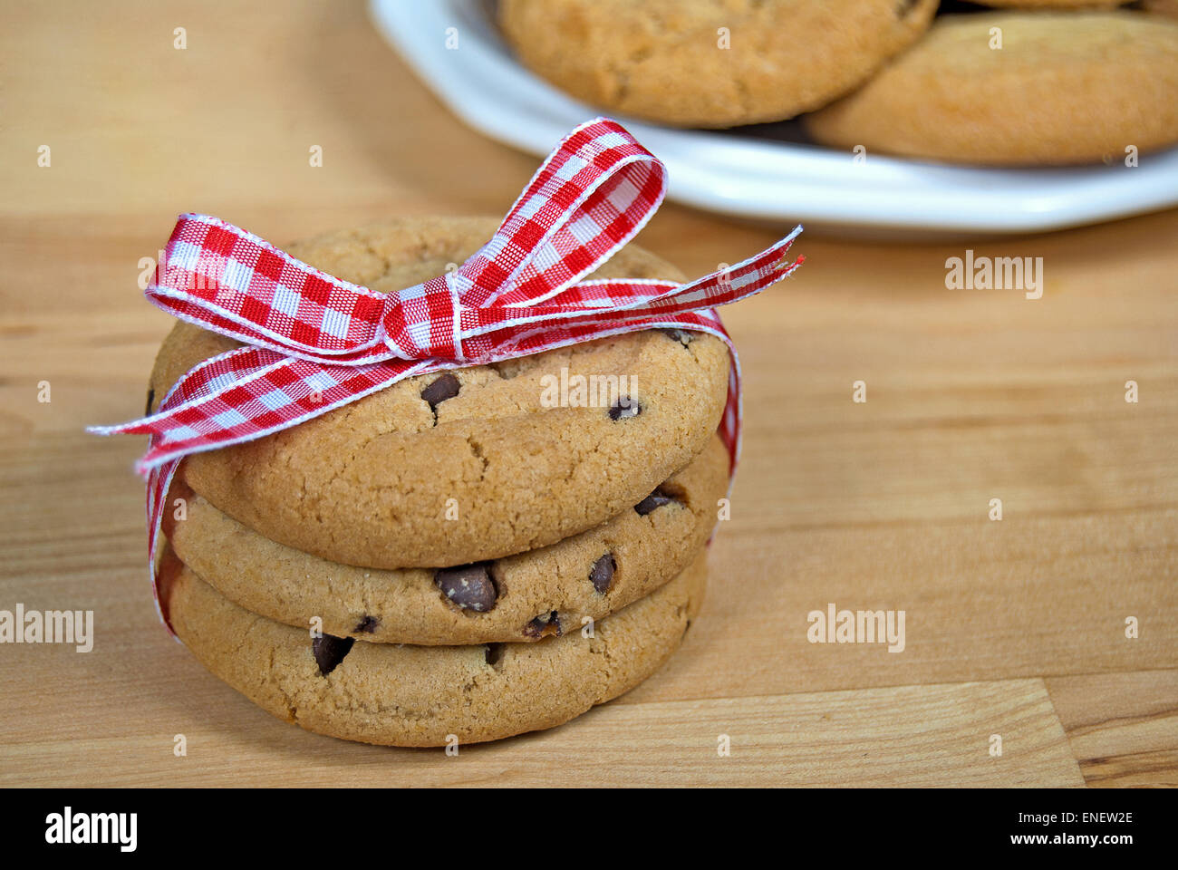 Stack of chocolate chip cookies with red and white gingham bow. Stock Photo