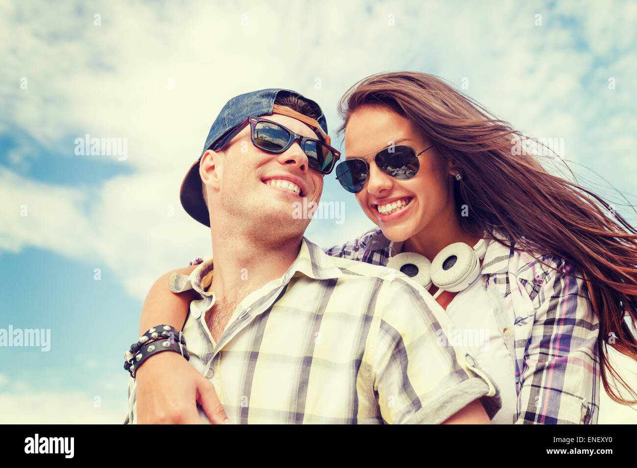 smiling teenagers in sunglasses having fun outside Stock Photo