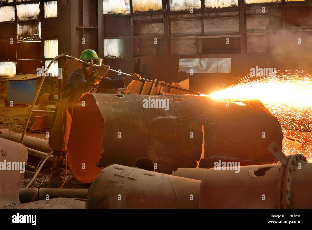 Welder working on a pipeline in construction site Stock Photo