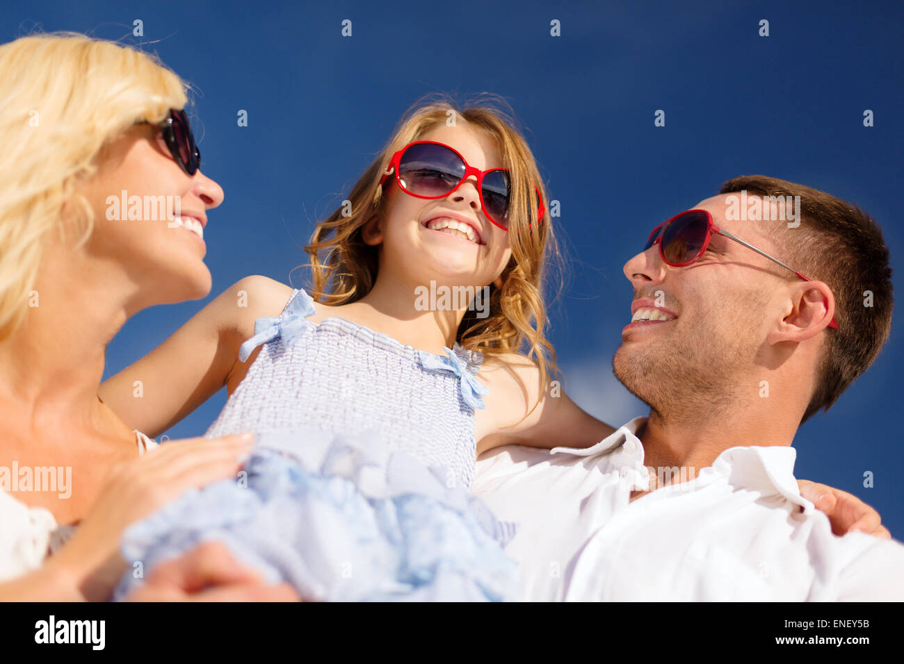 happy family in sunglasses over blue sky Stock Photo