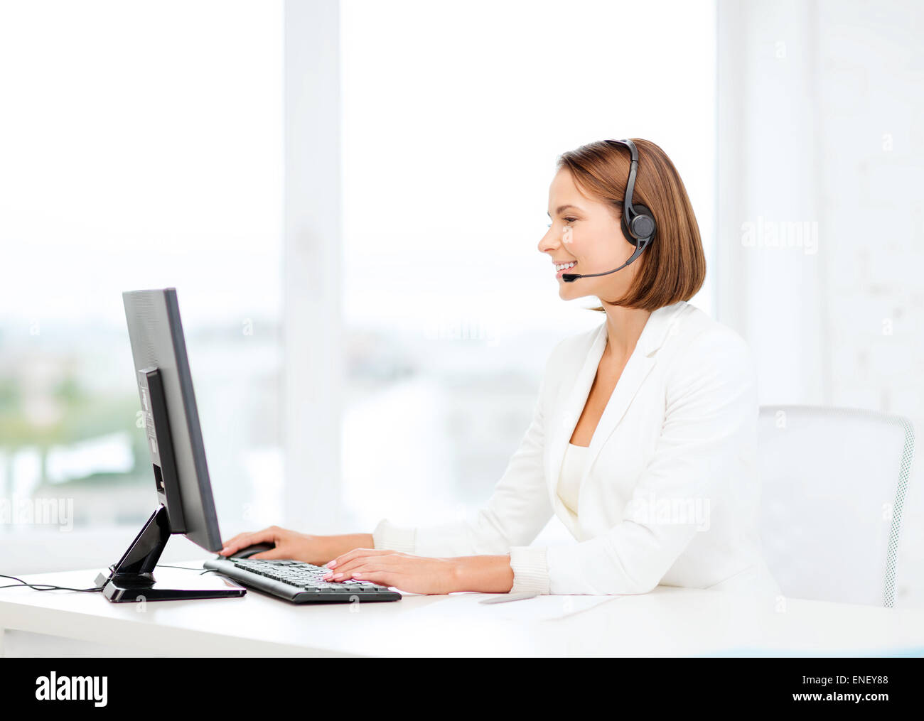 friendly female helpline operator with computer Stock Photo - Alamy