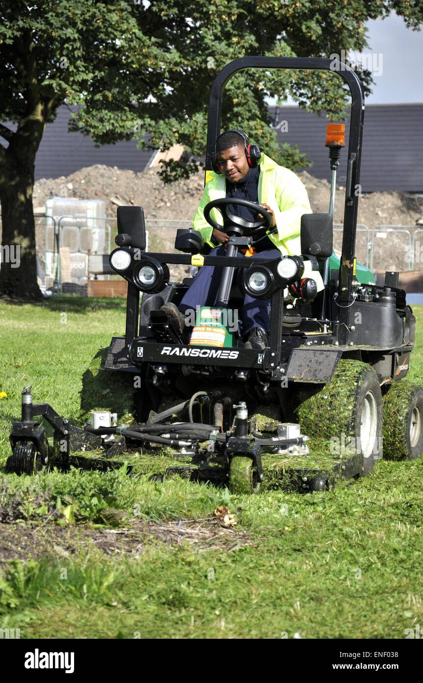 Motorised grass cutter mower operated by council employee Stock Photo Alamy