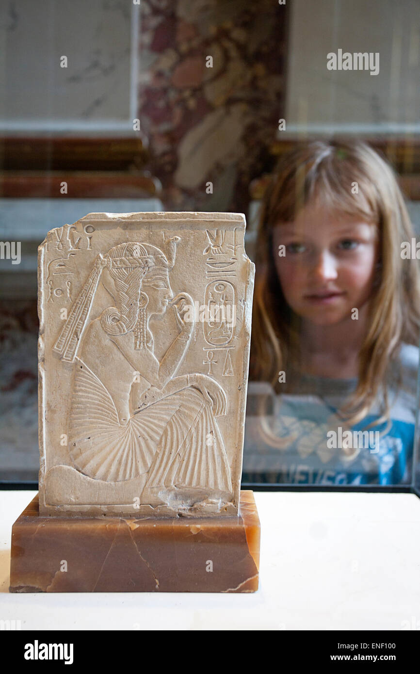 Young girl looking at an Egyptian artifact, Louvre Museum, Paris Stock Photo