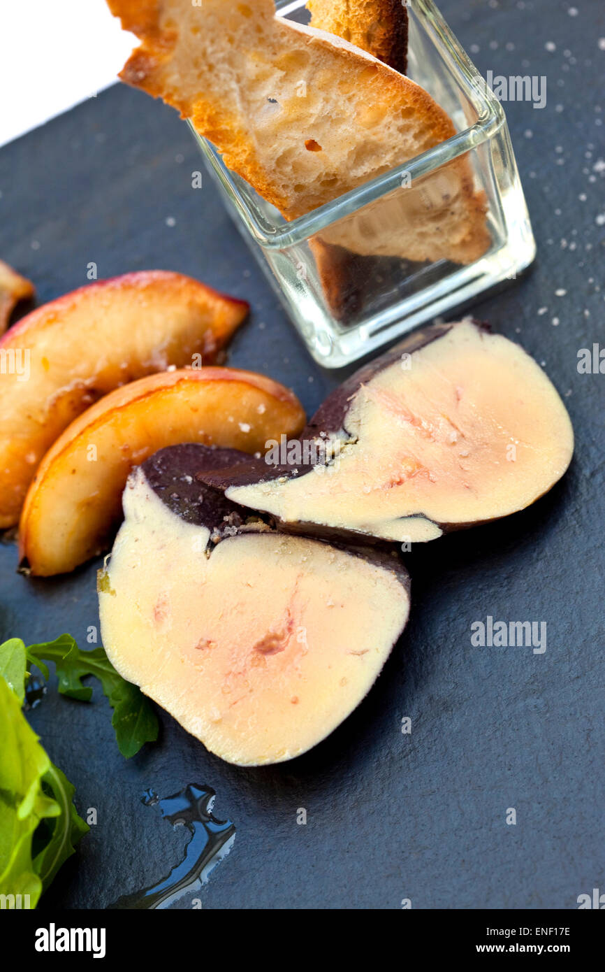 Foie gras, roasted apple and toast on a plate Stock Photo