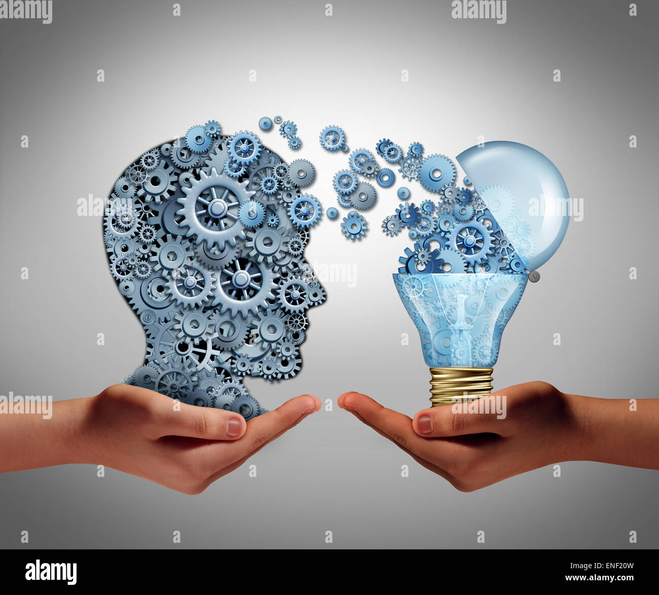 Concept of creating ideas and achievement symbol of aspiration success as two hands holding a group of connected gears shaped as a human head and an open lightbulb as an icon of imagination and innovation. Stock Photo