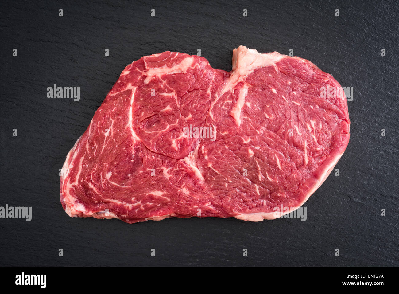 Fresh uncooked ribeye steak on black background Stock Photo Alamy