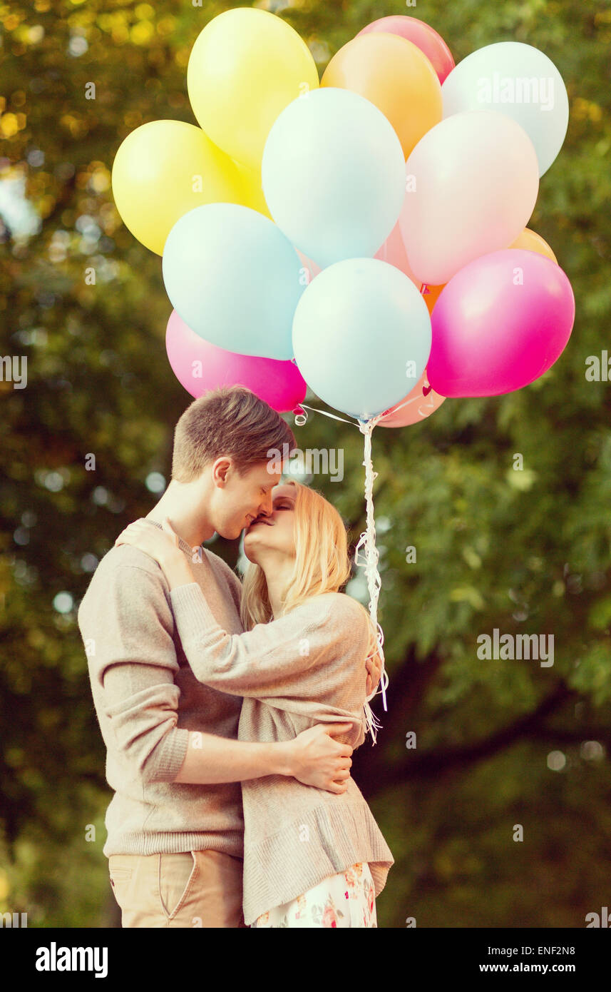 couple with colorful balloons kissing in the park Stock Photo - Alamy