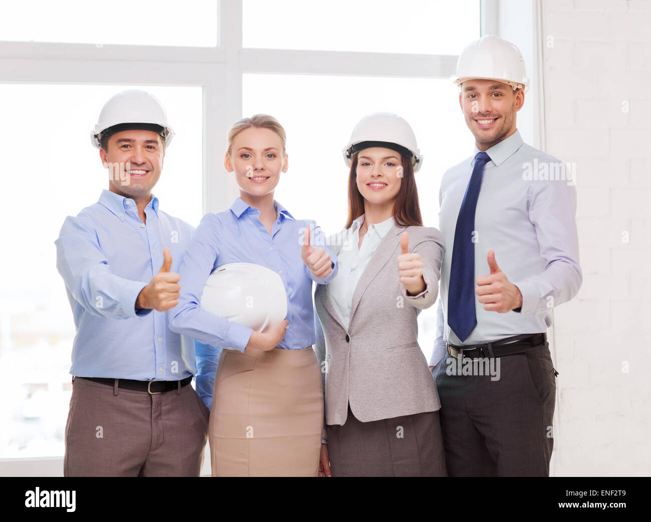 happy business team in office showing thumbs up Stock Photo - Alamy