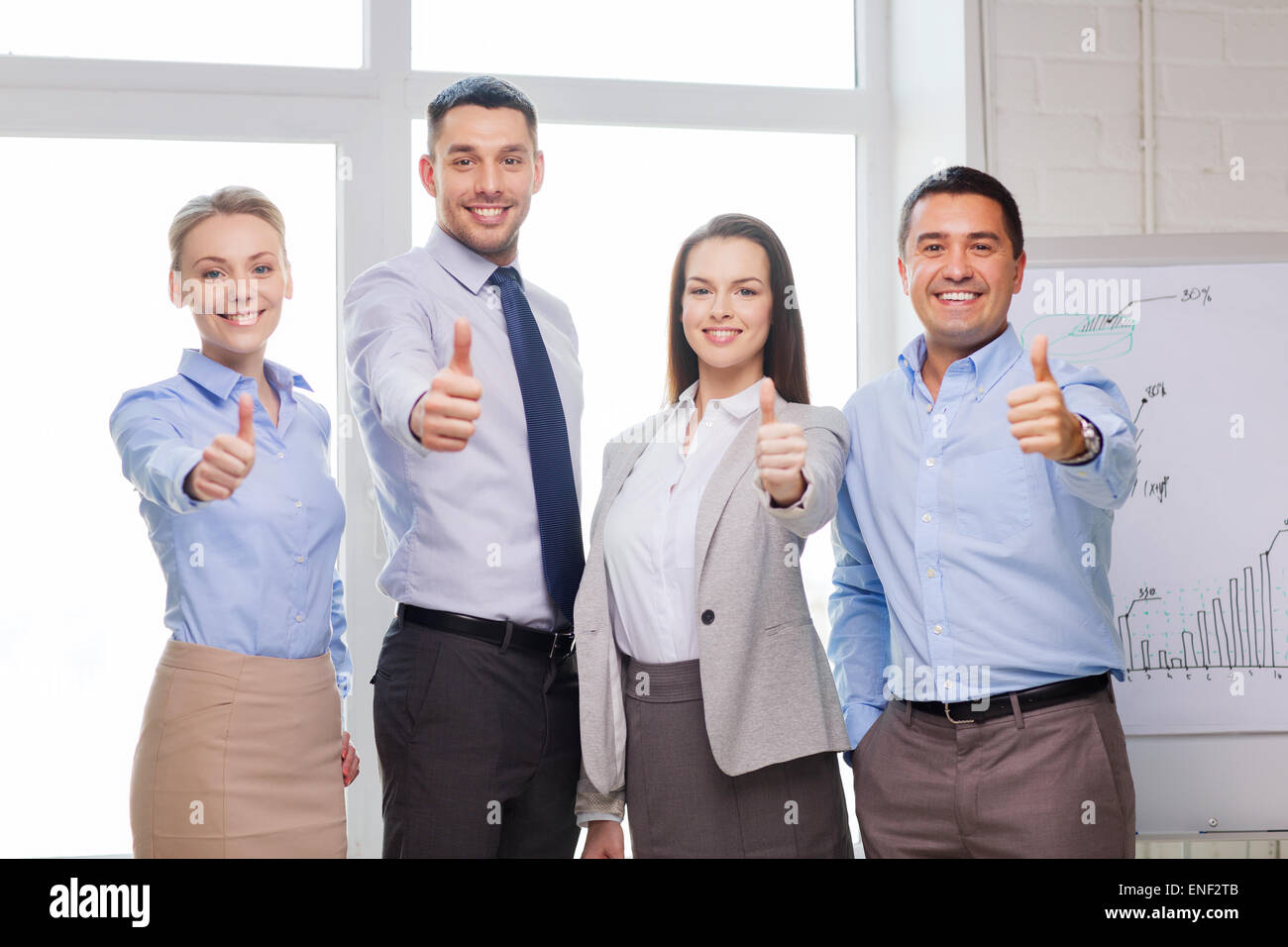 business team showing thumbs up in office Stock Photo - Alamy