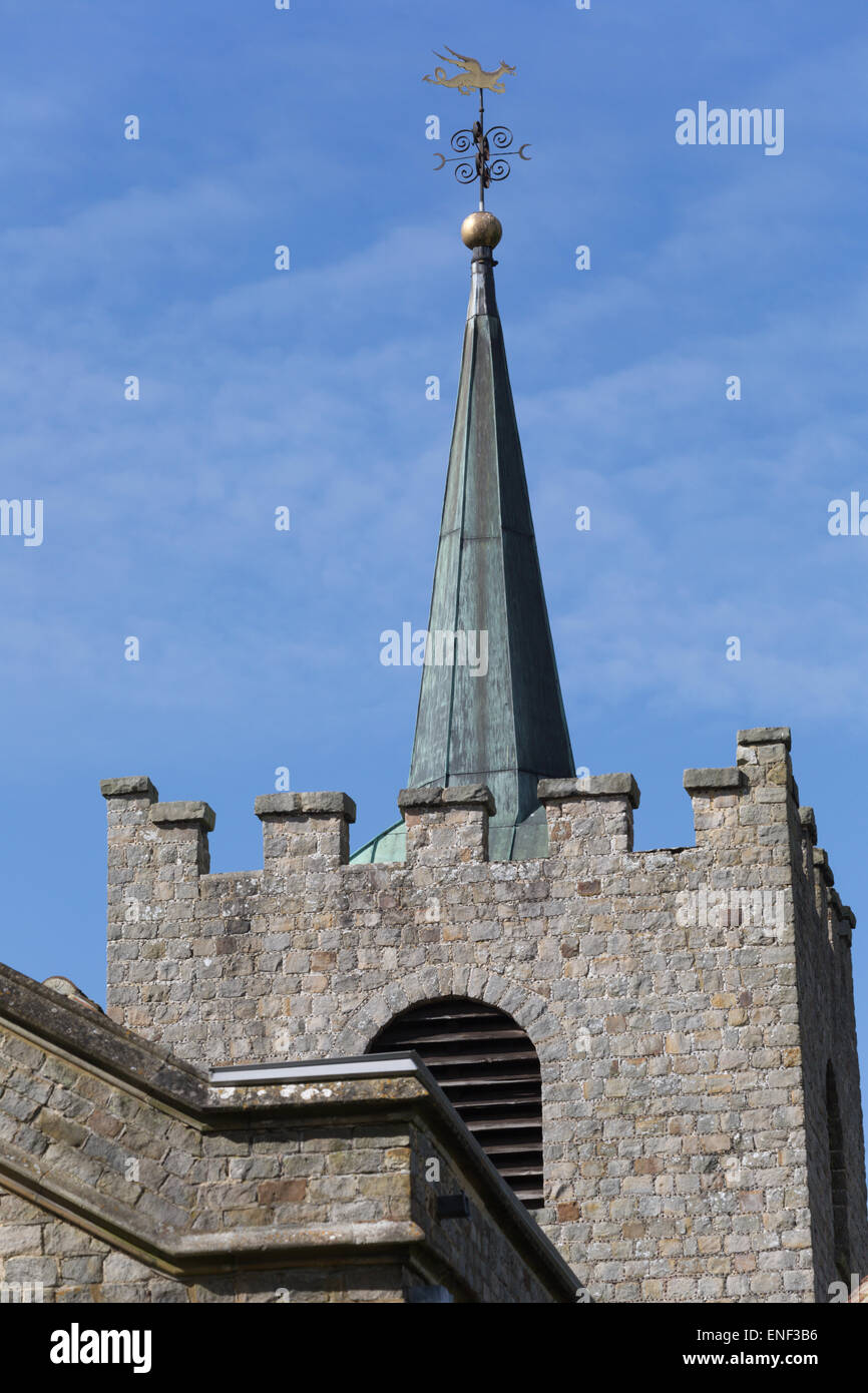 Traditional English church tower, topped with a metal clad spire and weather vane. Stock Photo