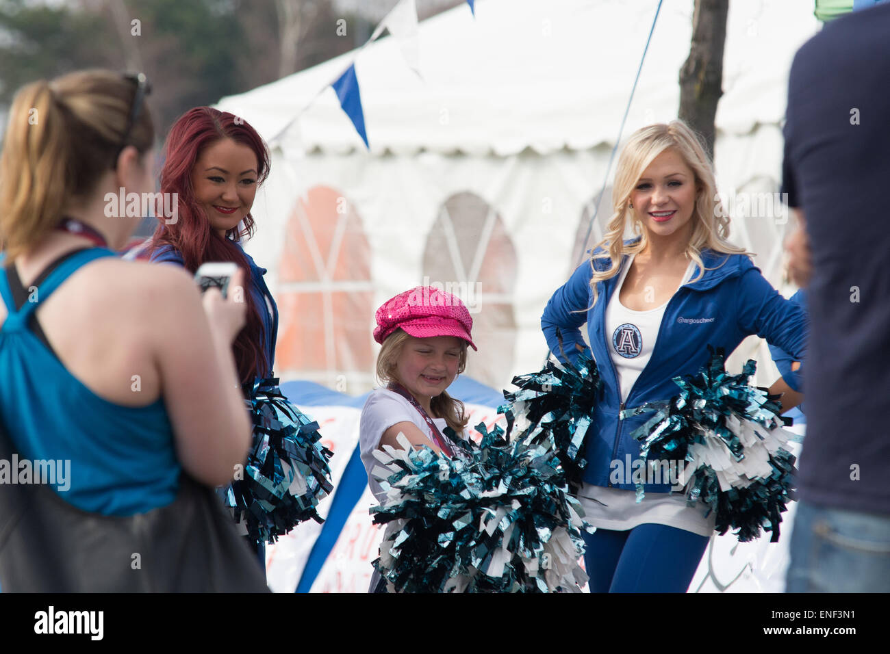 Toronto, Canada. 3rd May, 2015. Little girl after finishing the race enjoying with cheer leaders in Toronto Marathon. Credit:  NISARGMEDIA/Alamy Live News Stock Photo