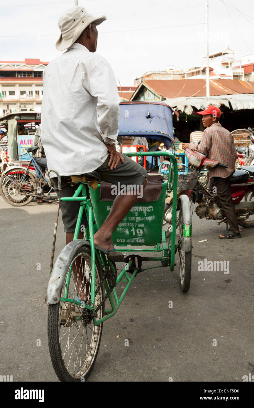 Rickshaw man waiting for customers in Phnom Penh, Cambodia, Asia. Stock Photo