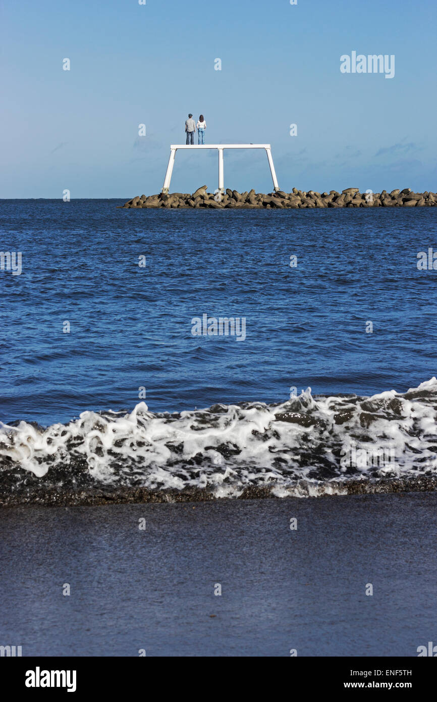 Sculptures in the sea. Public art at Newbiggin by the Sea with waves