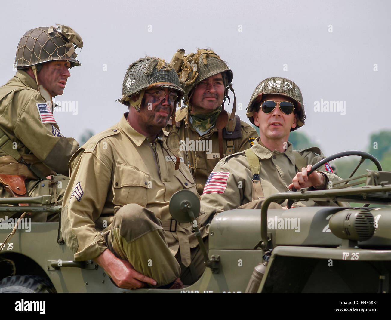 American US Allied Soldiers in WW2 Uniform seated in a Willys Jeep as part of the D-Day Anniversary, Normandy France Stock Photo
