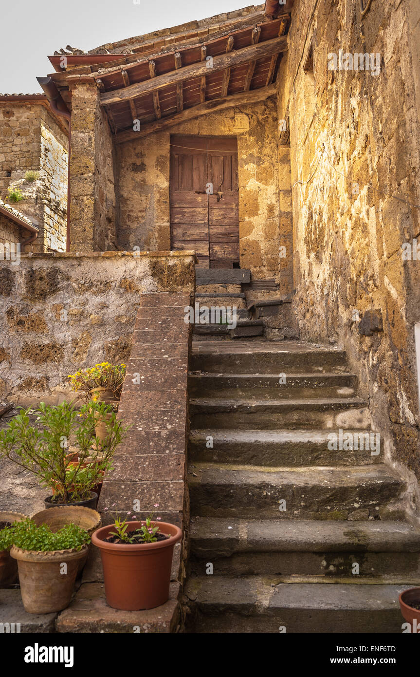 Stone steps leading to entrance of dwelling in Civita di Bagnoregio, Italy Stock Photo