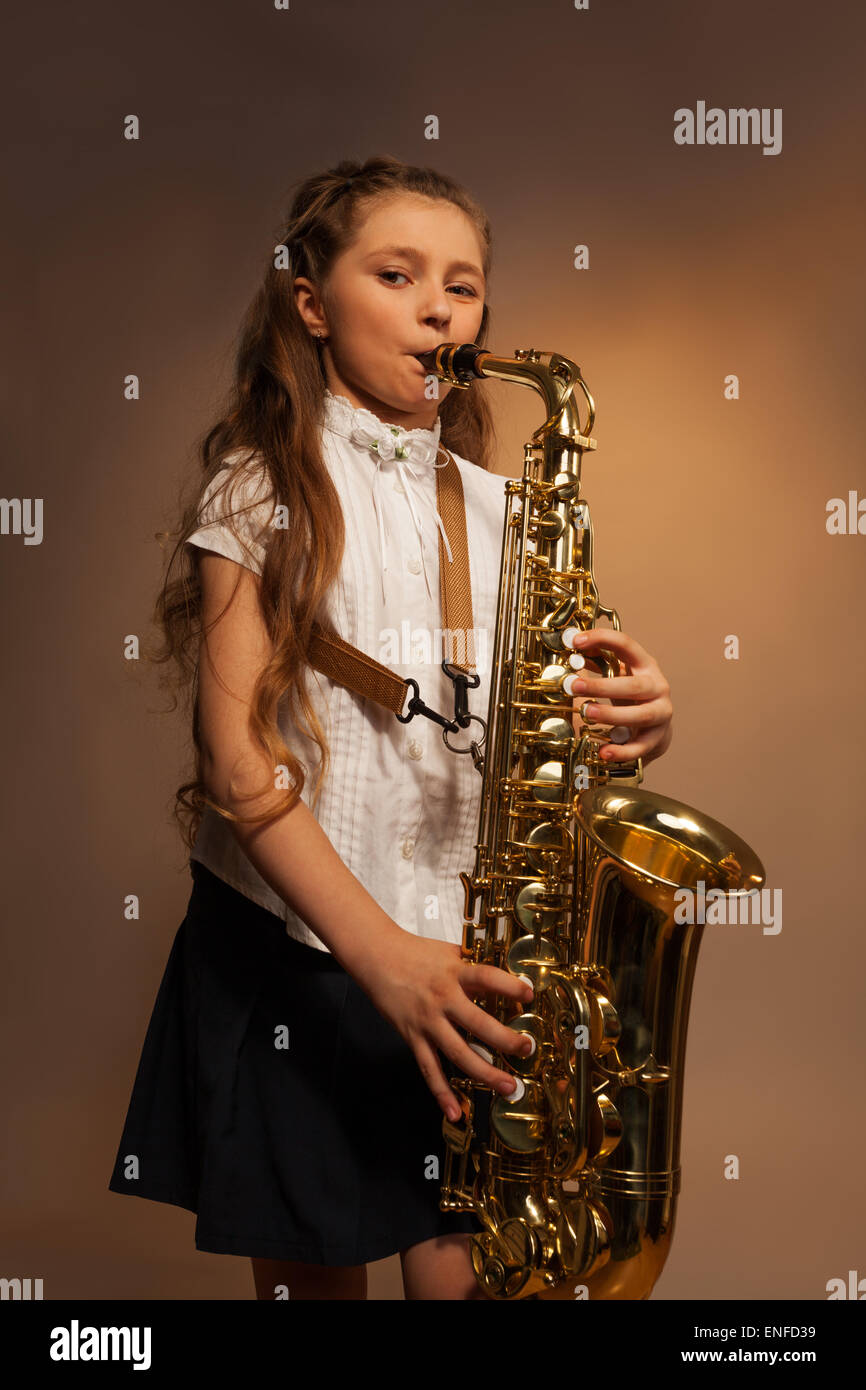 View of girl with long hair playing alto saxophone Stock Photo Alamy