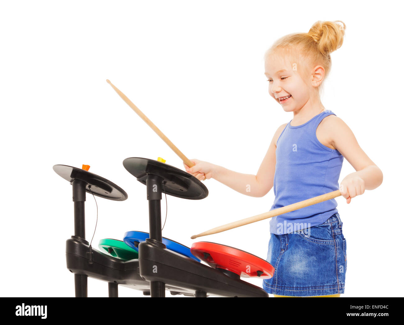 Cute small girl playing with drumsticks on cymbals Stock Photo
