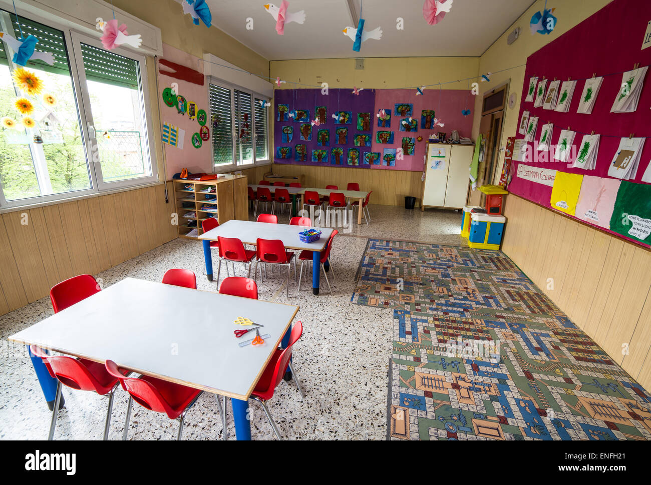 In a nursery class with tables and small red chairs for children Stock Photo