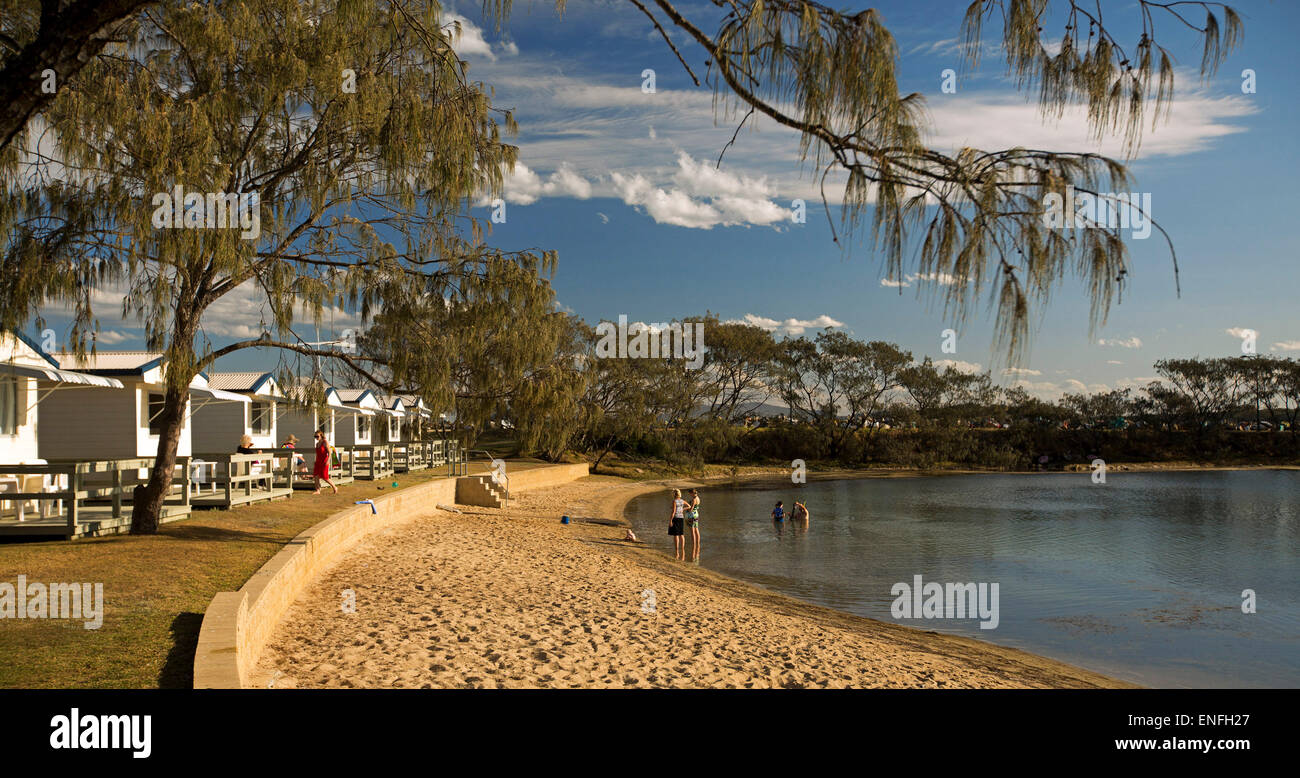 Panoramic View Of Waterfront Holiday Cabins Trees Beach And Blue