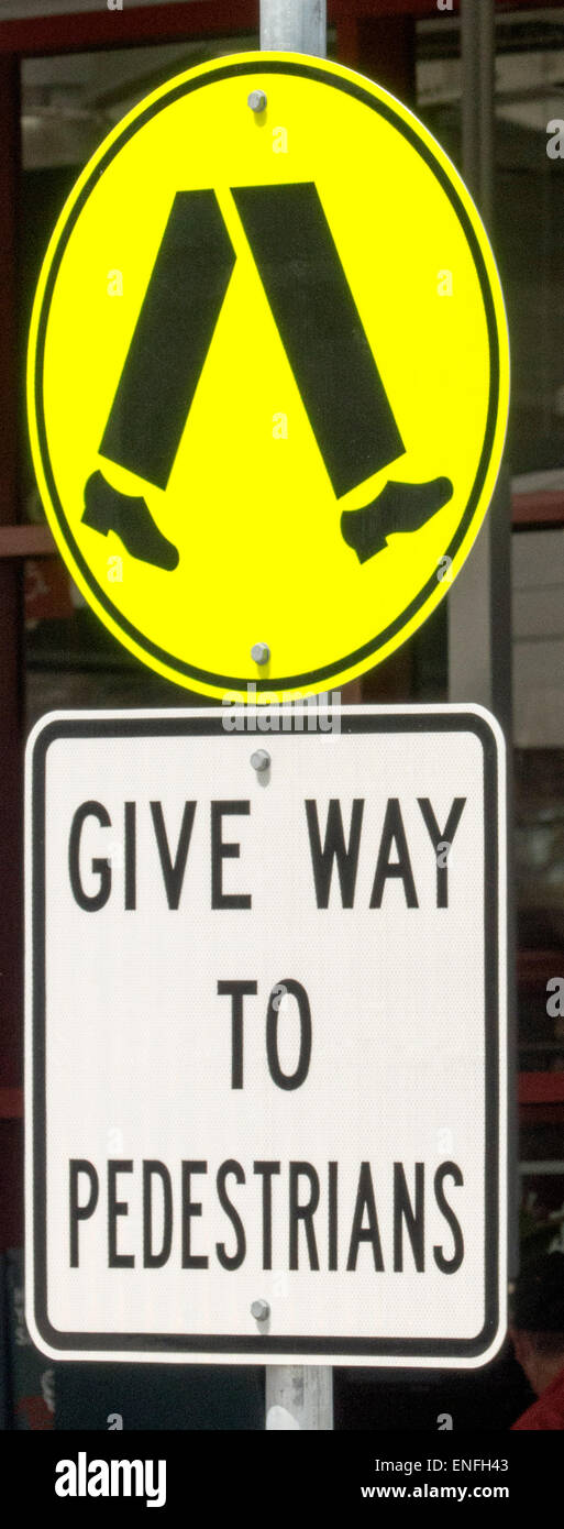 Road sign at zebra crossing warning drivers to give way to pedestrians