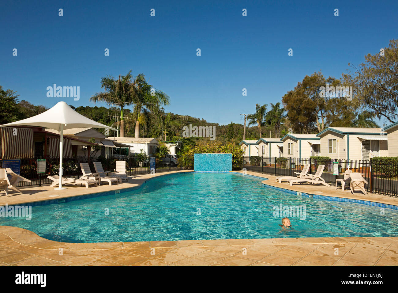 Swimming pool and tourist holiday accommodation under blue sky at Nambucca Heads NSW Australia Stock Photo