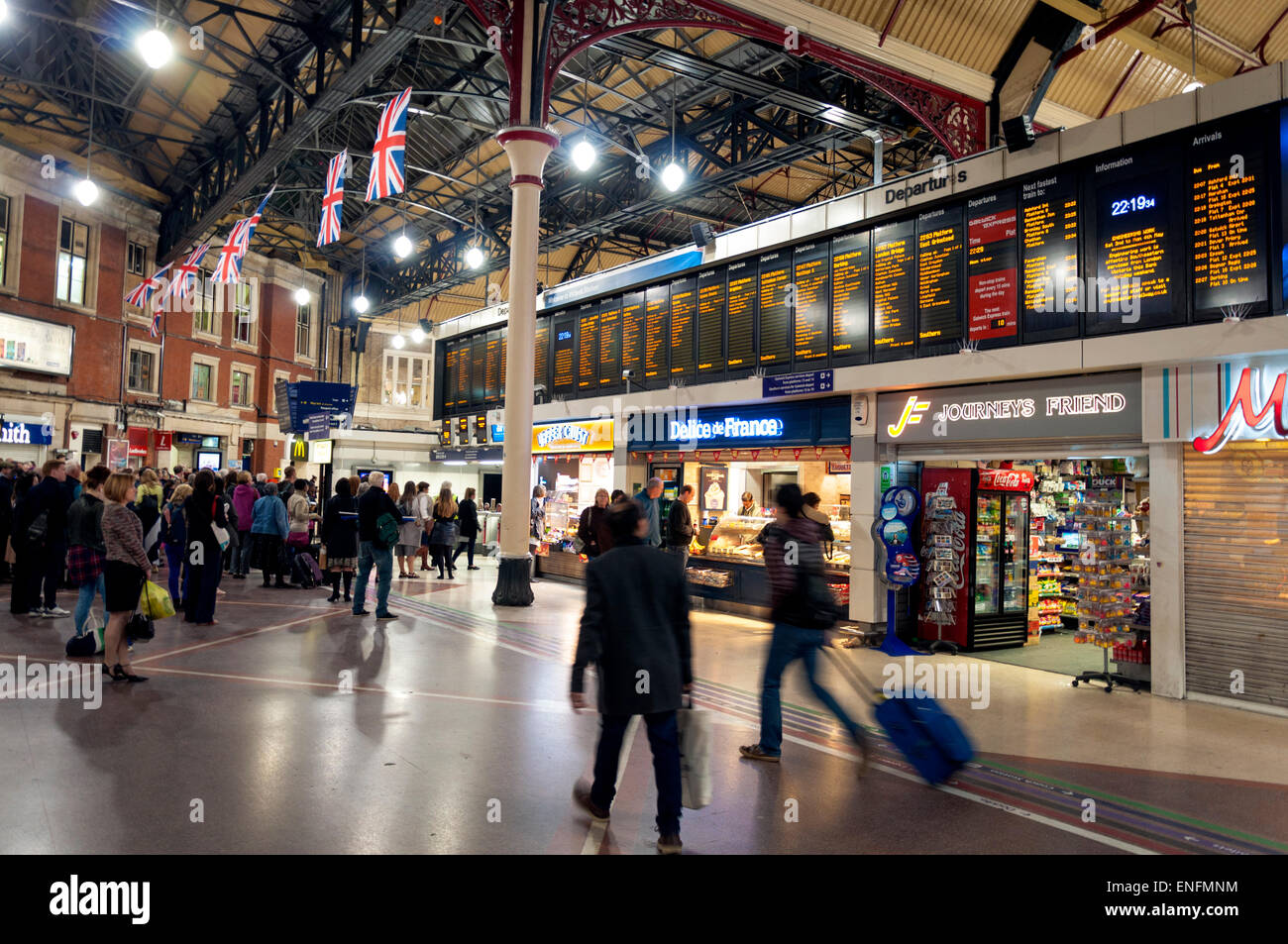 Commuters passengers look at train departure board at London Victoria railway station Stock Photo