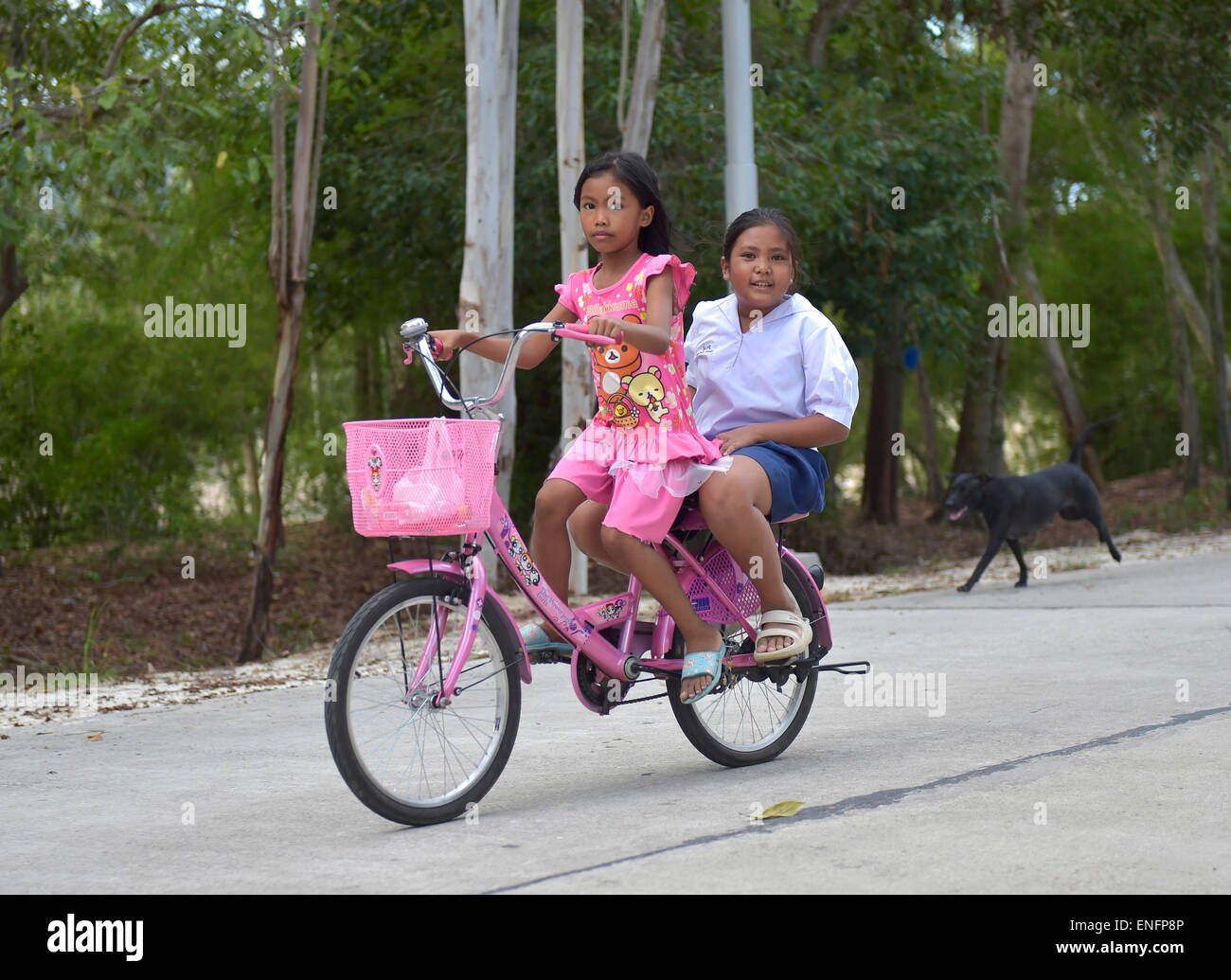 Two girls on a bike, Ko Samui, Thailand Stock Photo