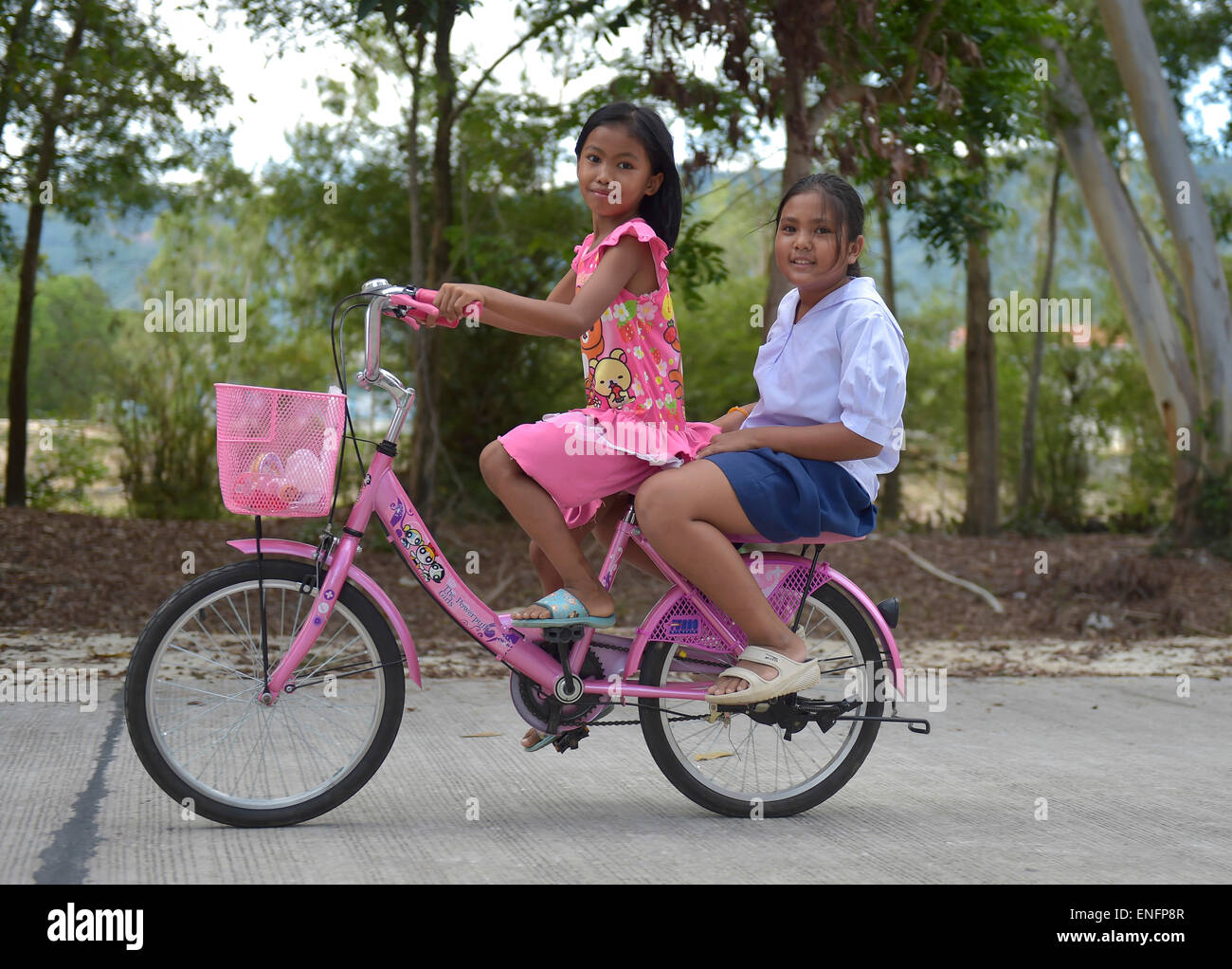 Two girls on a bike, Ko Samui, Thailand Stock Photo