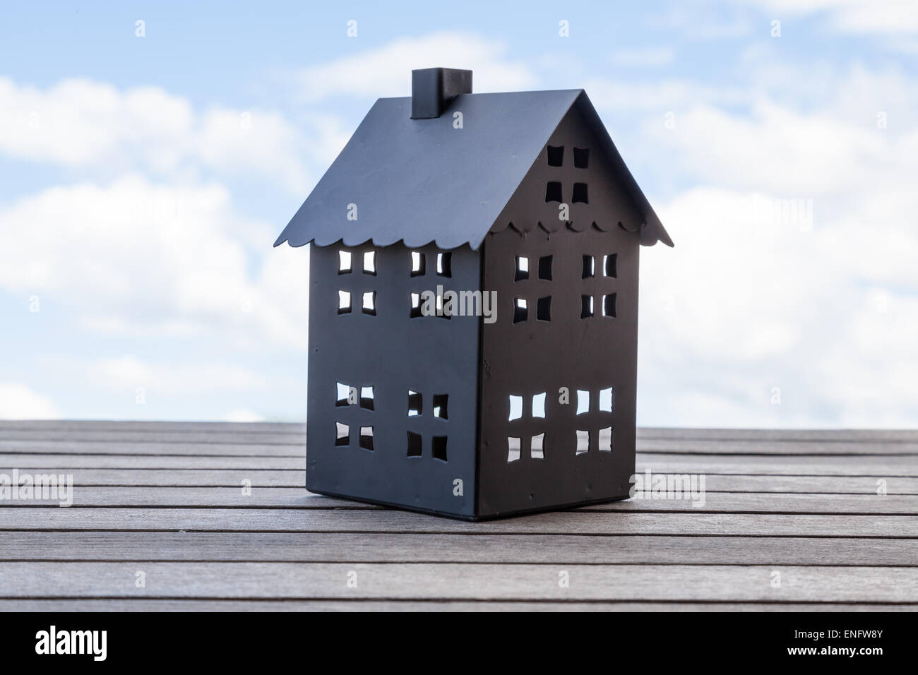 Black house with blue sky in the background. Suitable for concepts such as house sales and broker. Stock Photo