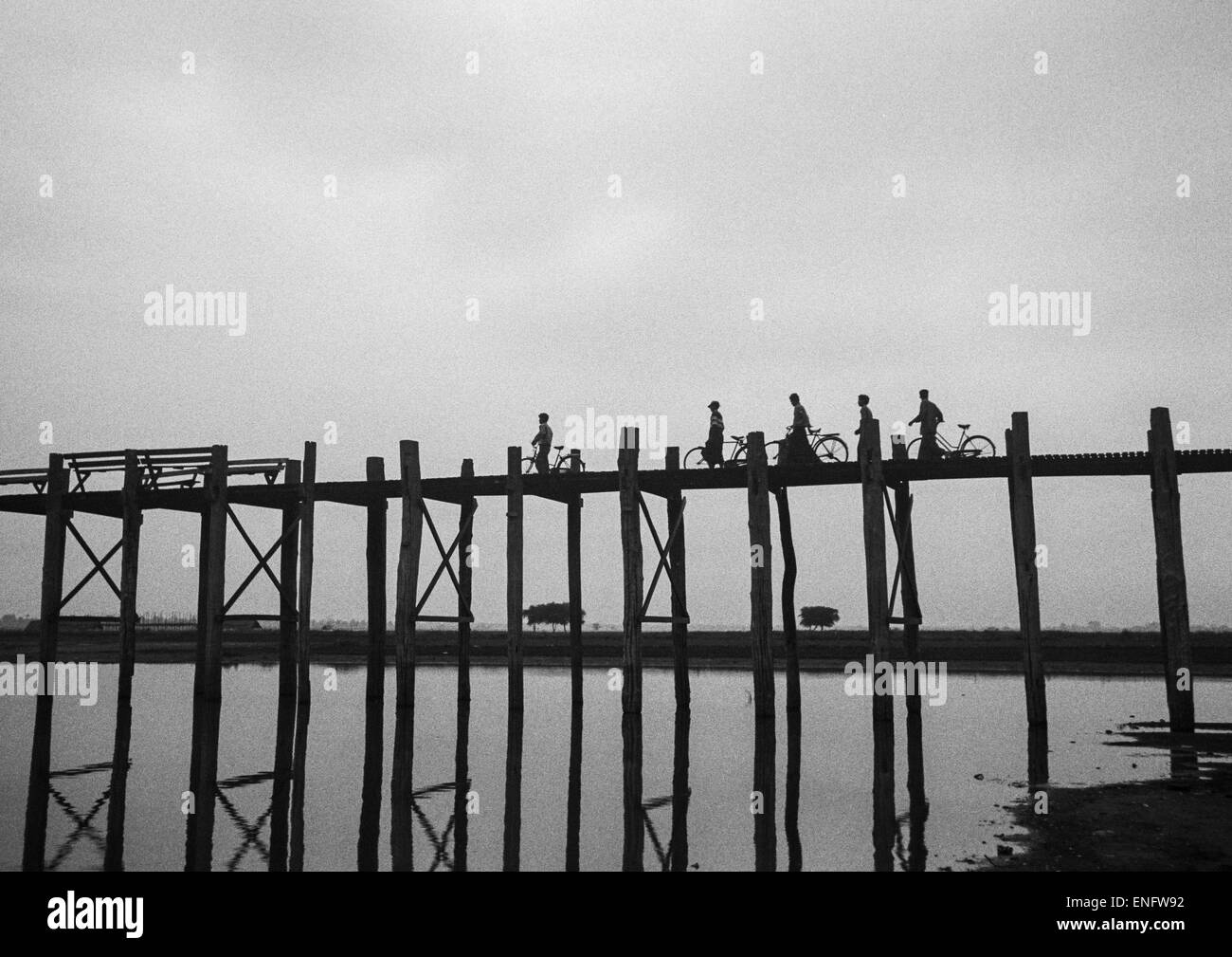 People Crossing U Bein Bridge In Amarapura, Mandalay, Myanmar Stock Photo