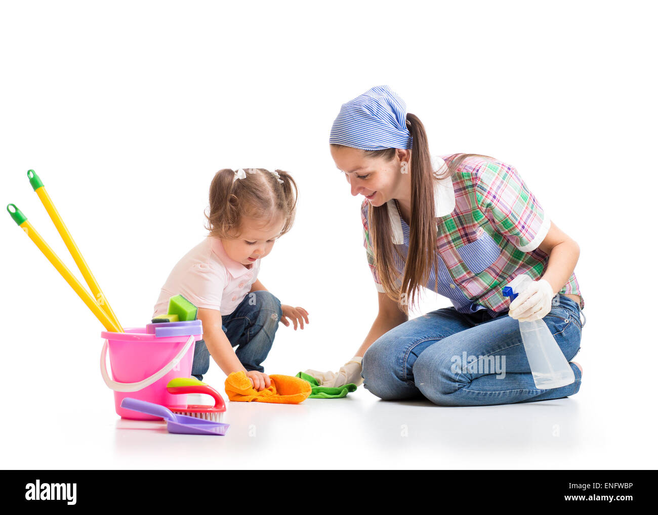 cute mother teaches daughter child cleaning room Stock Photo