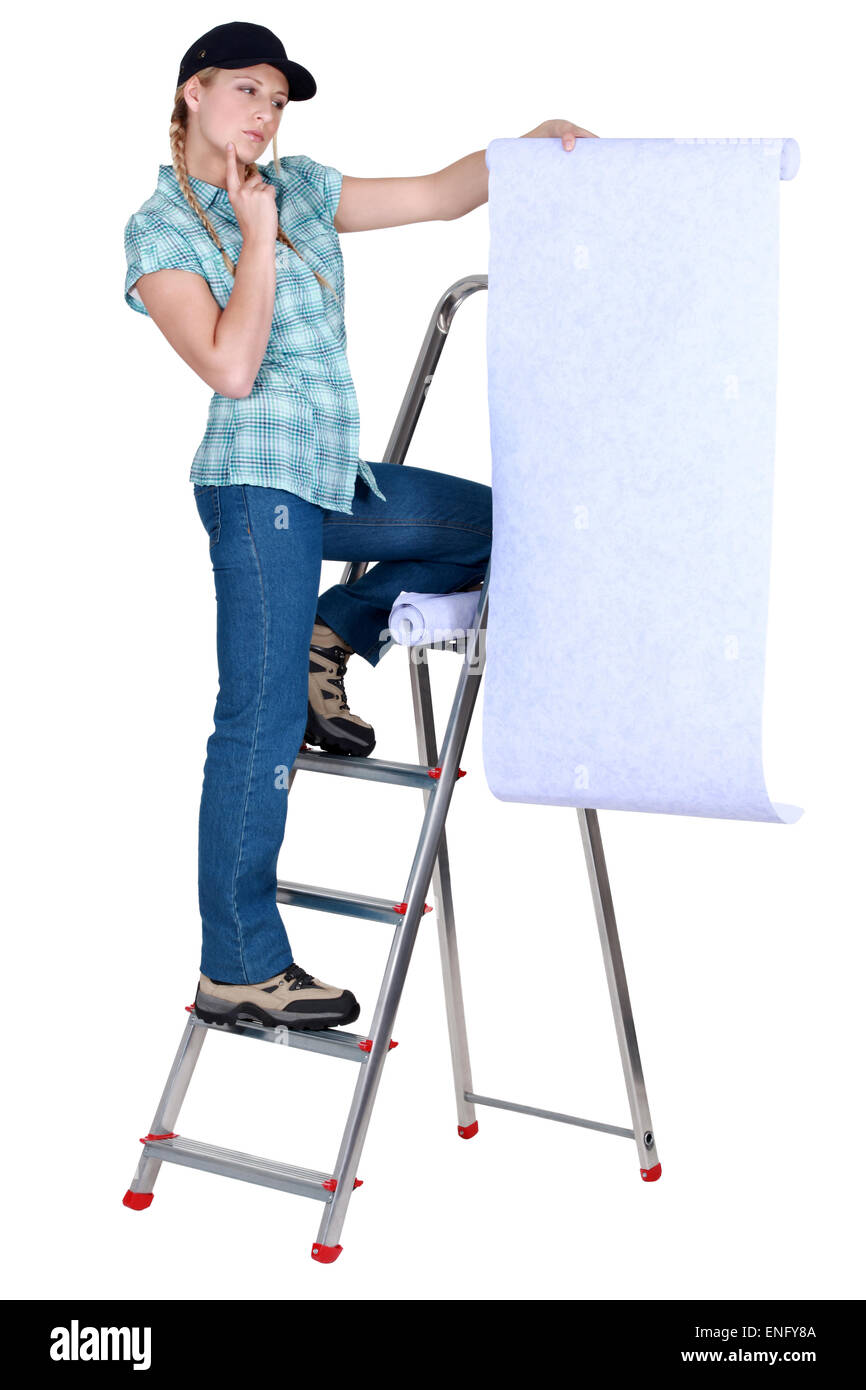 craftswoman looking at a wallpaper and thinking Stock Photo - Alamy