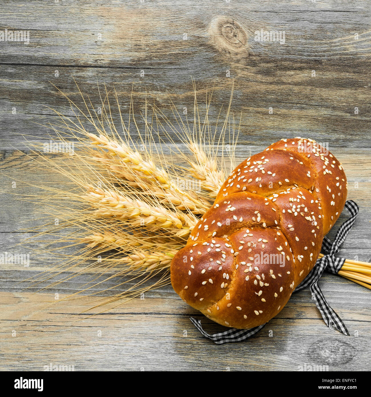 Bun with sesame seeds and ears on wooden  background. Stock Photo