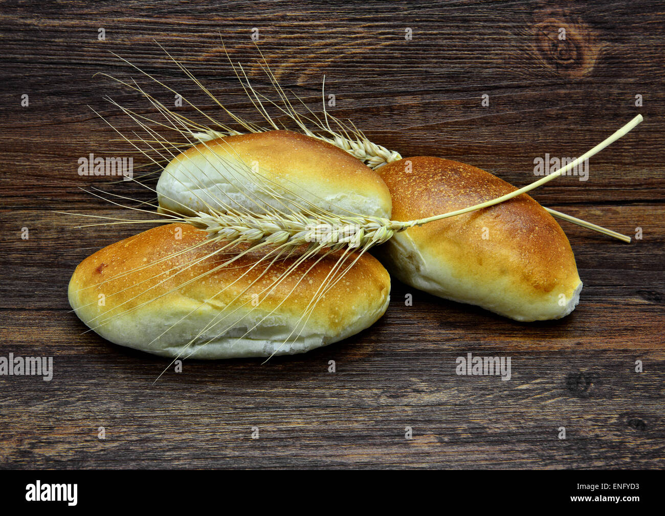 Homemade buns and ears on rustic wooden background. Stock Photo