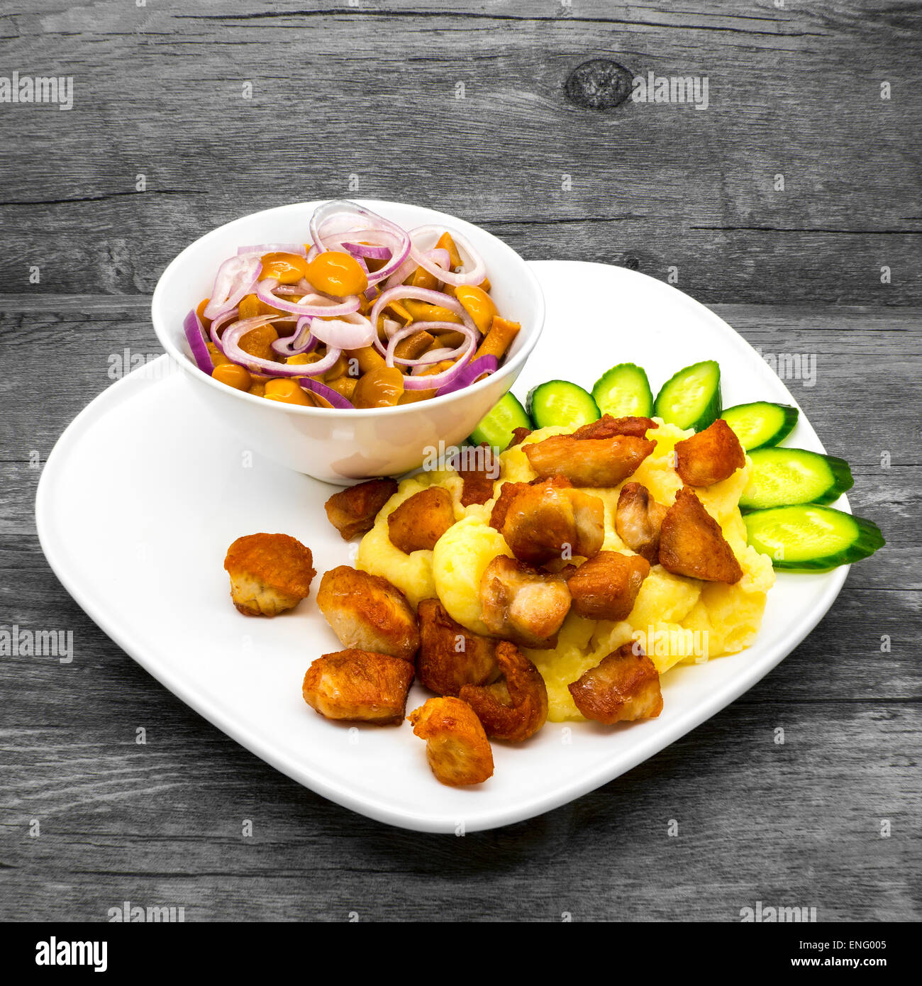 Mashed potatoes with chicken and mushrooms on a wooden background Stock Photo