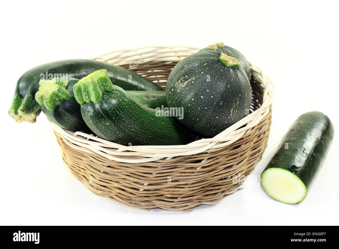 green, raw zucchini in front of white background Stock Photo