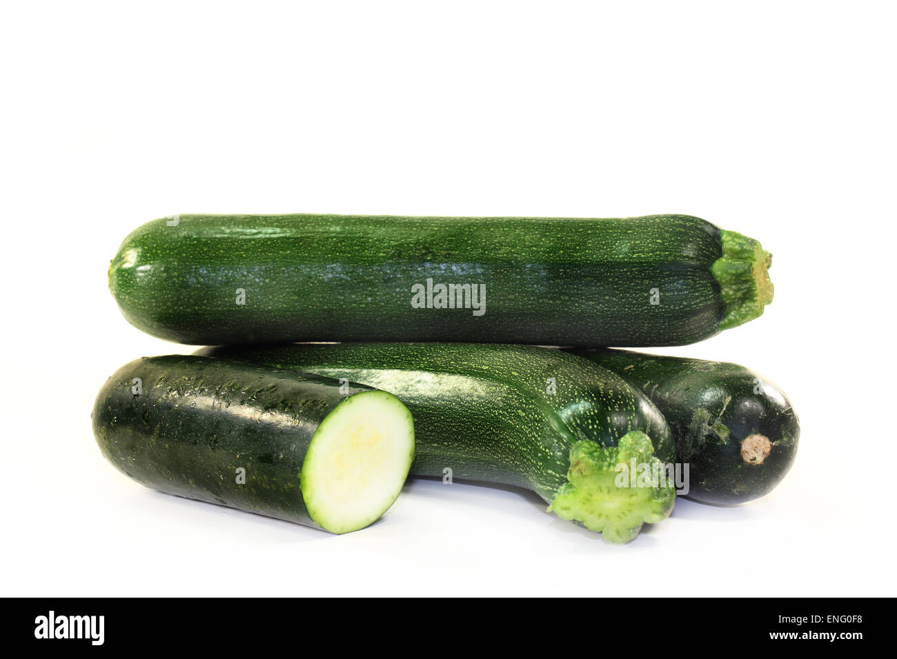 green, raw zucchini in front of white background Stock Photo
