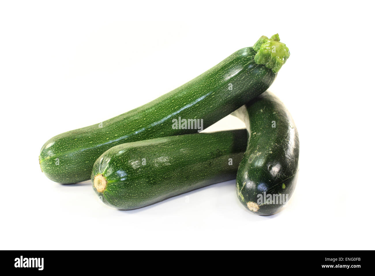 green, raw zucchini in front of white background Stock Photo