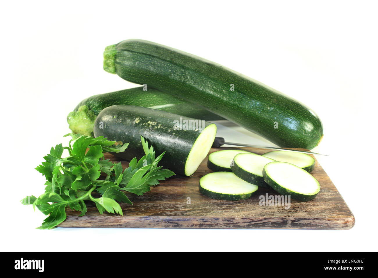 green, raw zucchini in front of white background Stock Photo