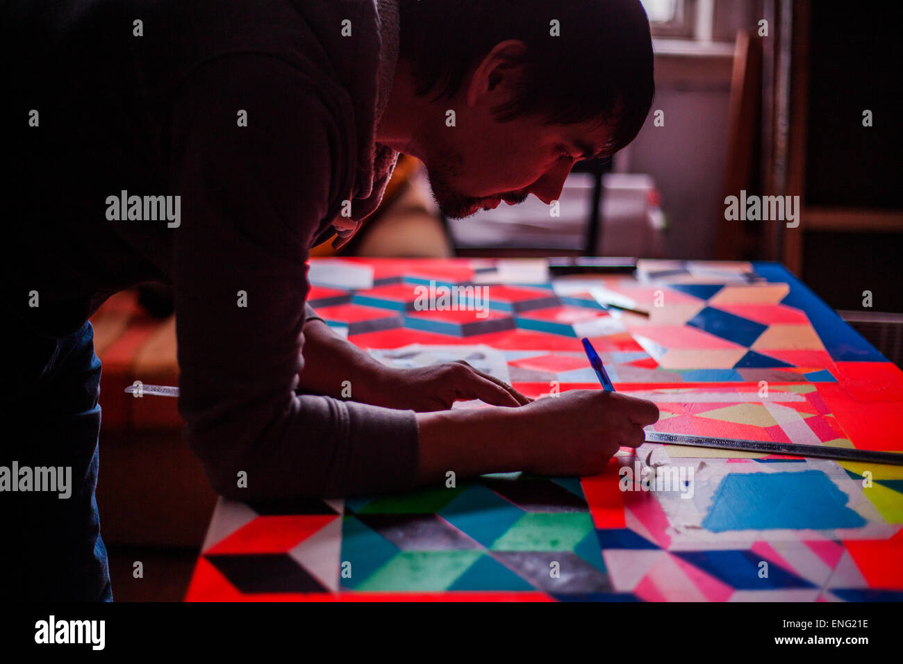Mari man designing colorful table Stock Photo