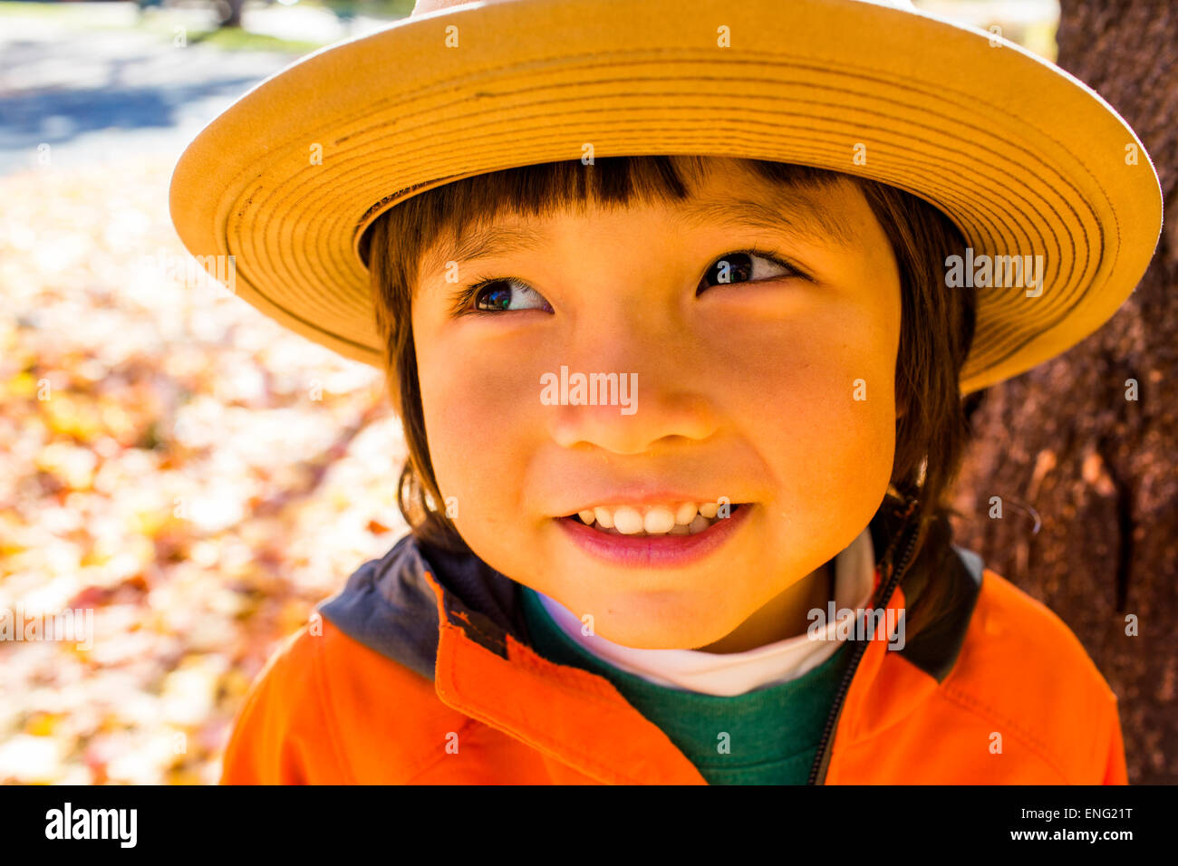 Close up of smiling mixed race boy wearing sun hat Stock Photo