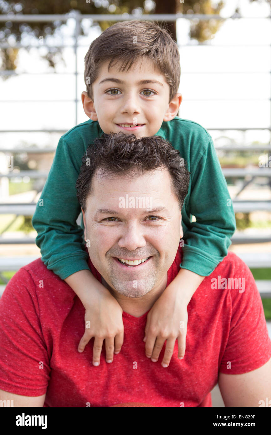 Caucasian father and son playing on bleachers Stock Photo