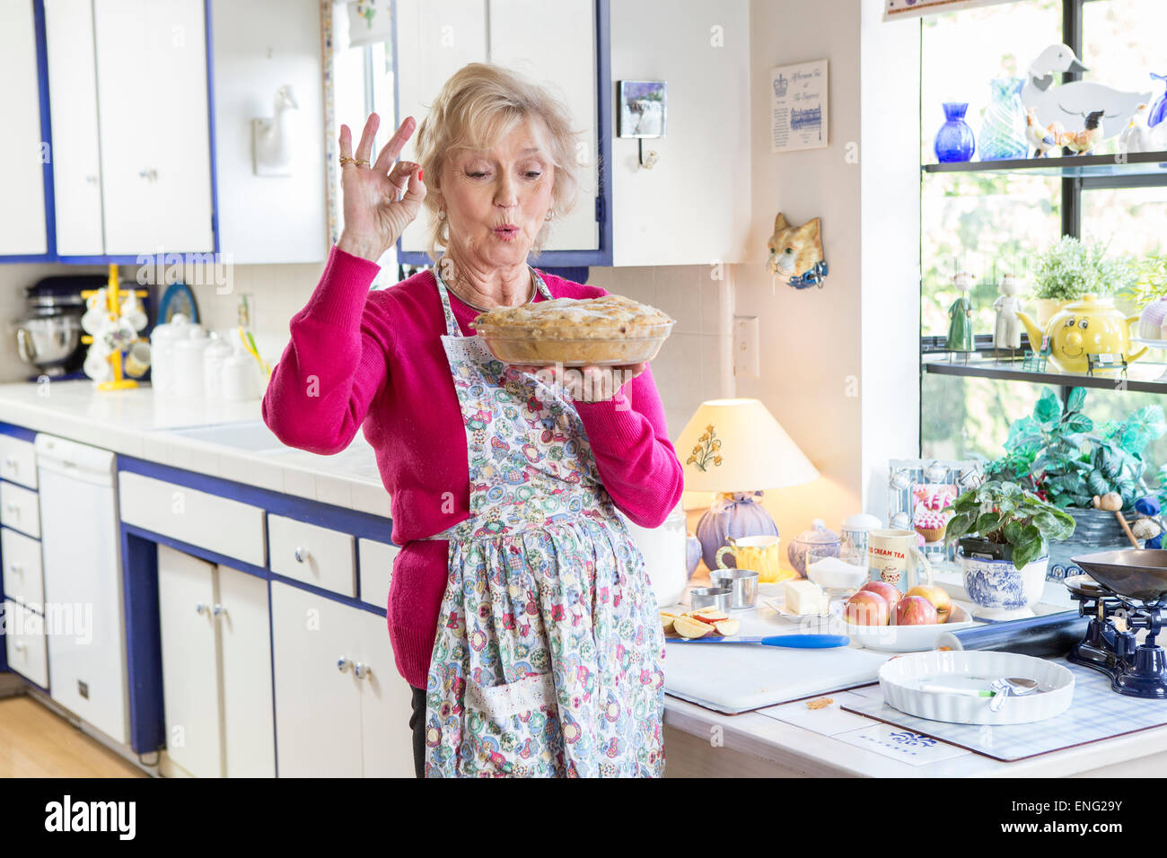 Older Caucasian woman baking pie in kitchen Stock Photo