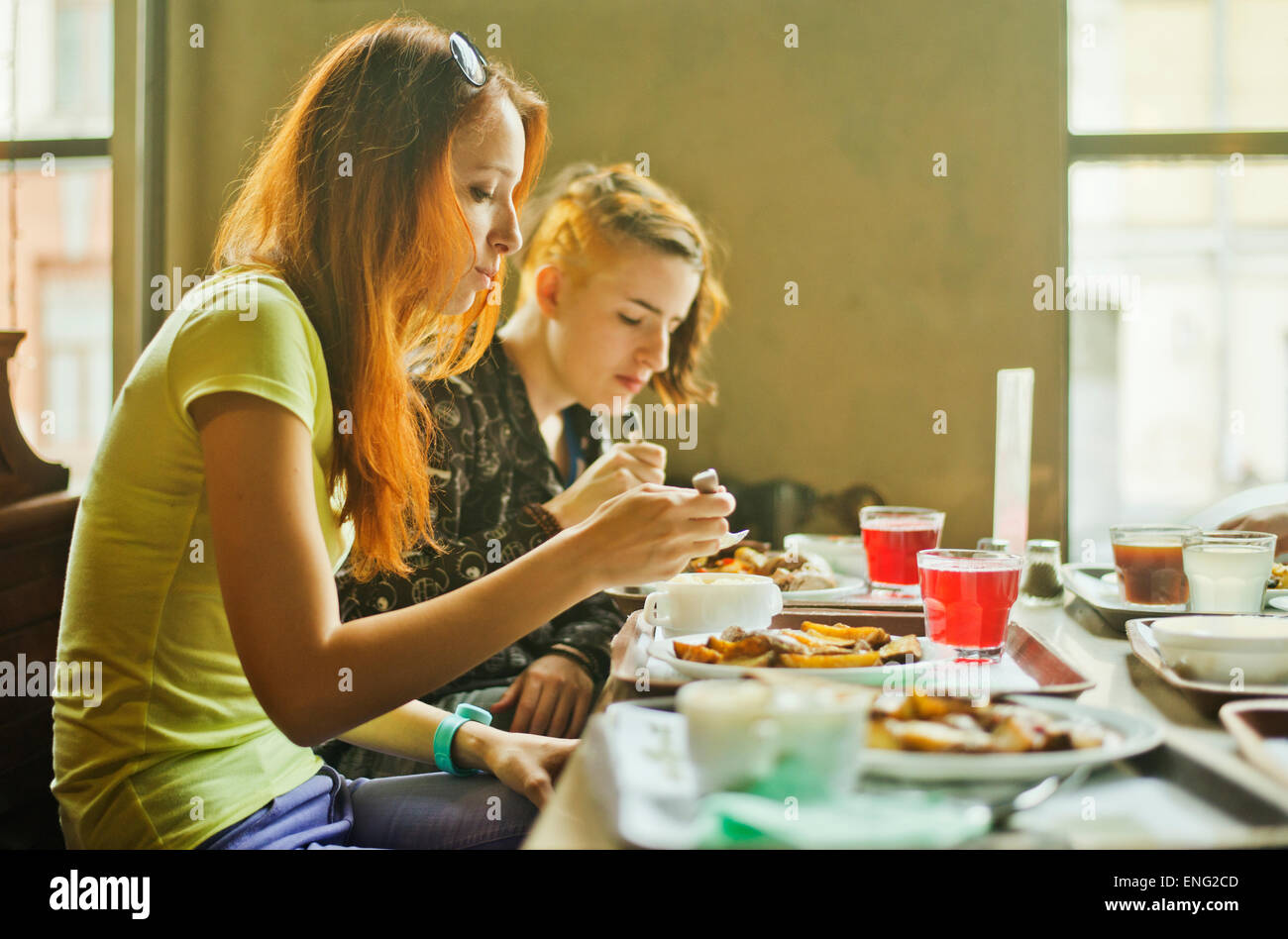 Caucasian women eating in dining room Stock Photo
