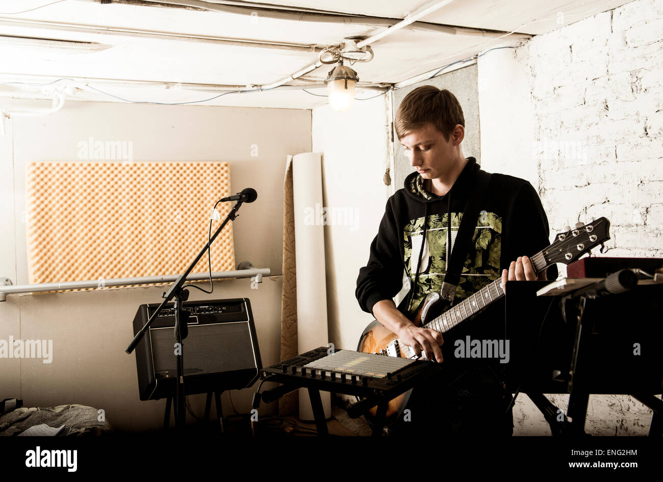 Caucasian man playing electric guitar in rock band Stock Photo