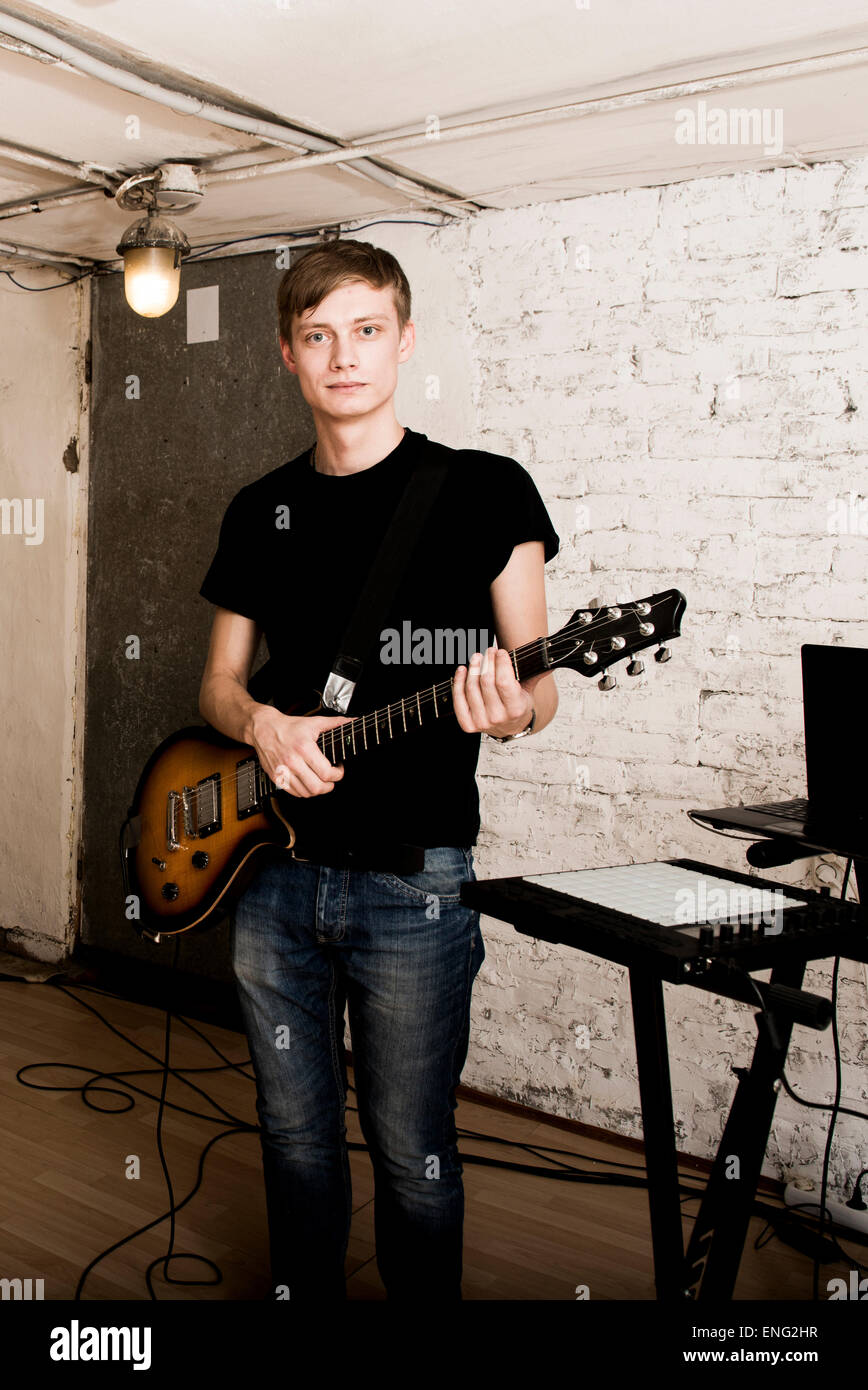 Caucasian man playing electric guitar in rock band Stock Photo