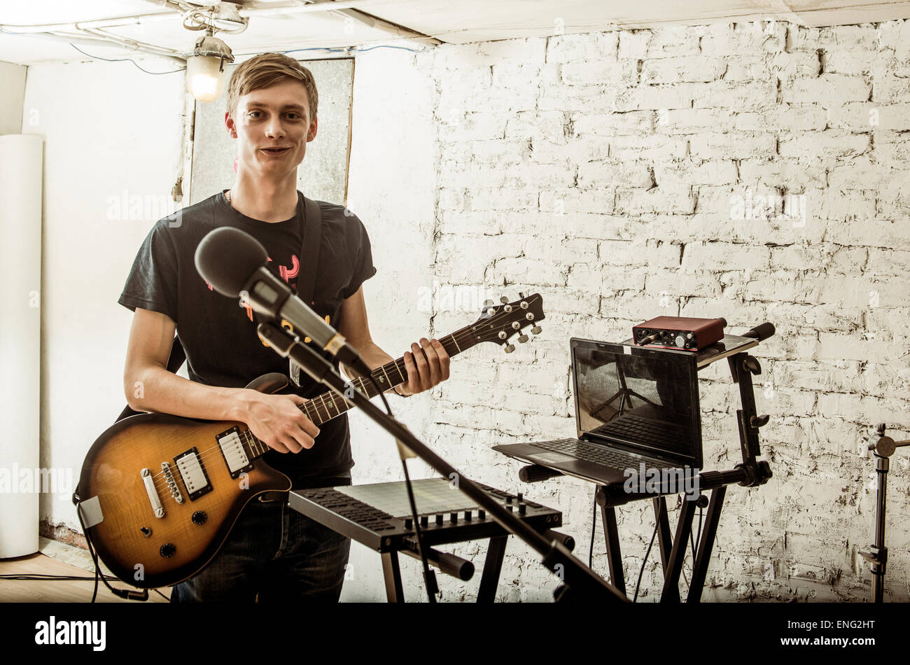 Caucasian man playing electric guitar in rock band Stock Photo