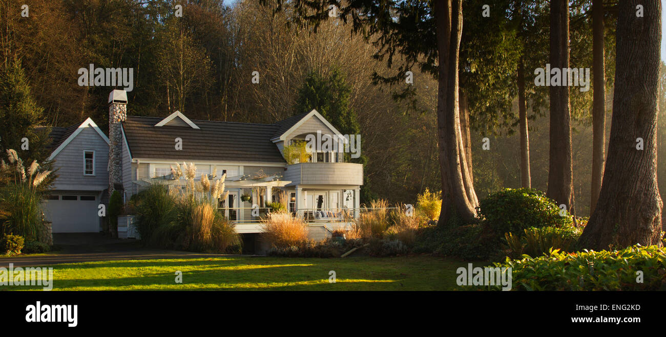 Ornate house and backyard near rural forest Stock Photo